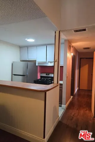 a spacious bedroom with a bed and wooden floor