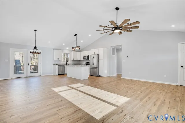 a view of a kitchen with a dishwasher cabinets and wooden floor