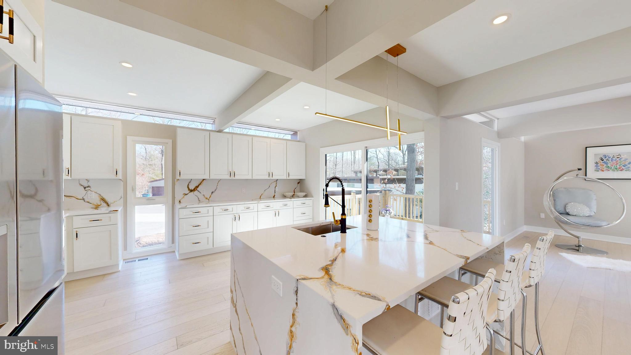 11101 Wedge Drive Reston, VA 20190 - Photo 12 of 55 a kitchen with a table chairs refrigerator and cabinets