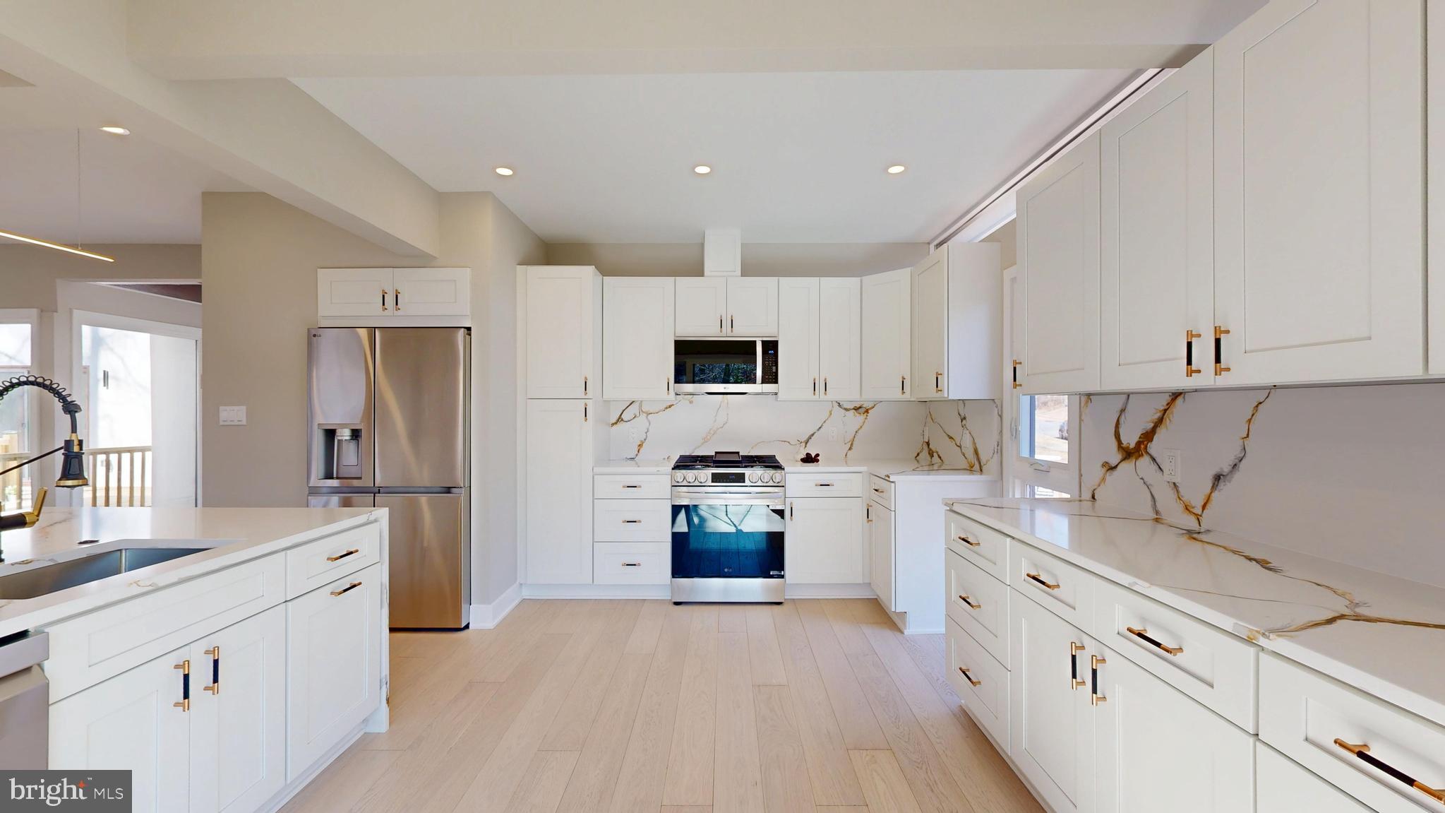 11101 Wedge Drive Reston, VA 20190 - Photo 15 of 55 a kitchen with stainless steel appliances a refrigerator sink and stove