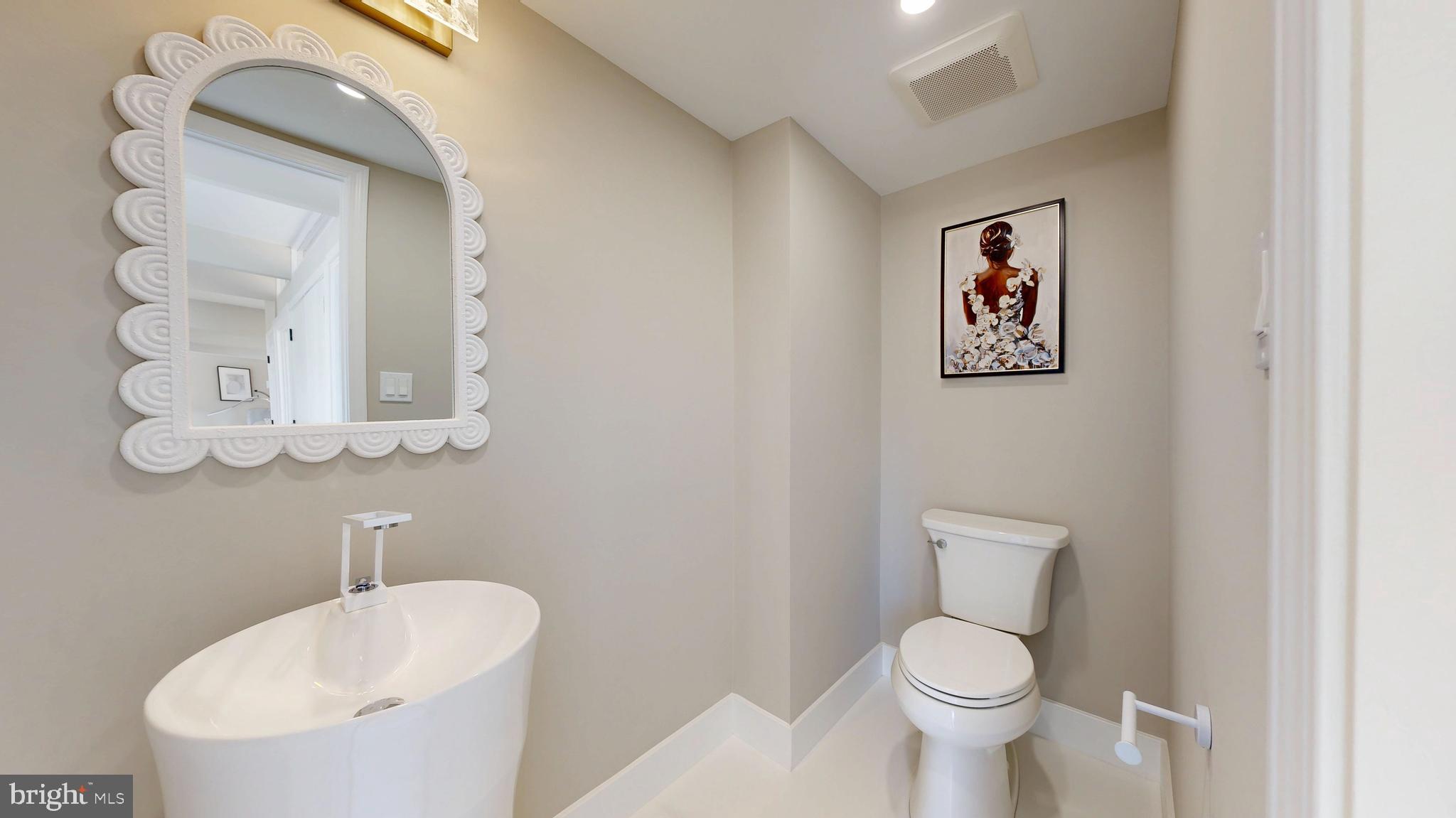 11101 Wedge Drive Reston, VA 20190 - Photo 18 of 55 a white toilet sitting next to a bathroom sink