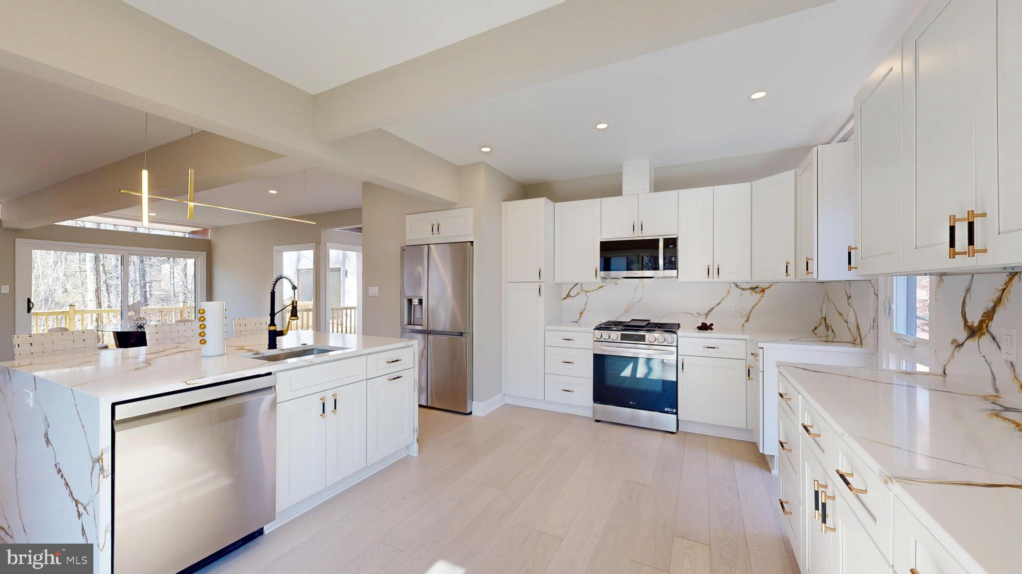 11101 Wedge Drive Reston, VA 20190 - Photo 2 of 55 a kitchen with white cabinets and stainless steel appliances