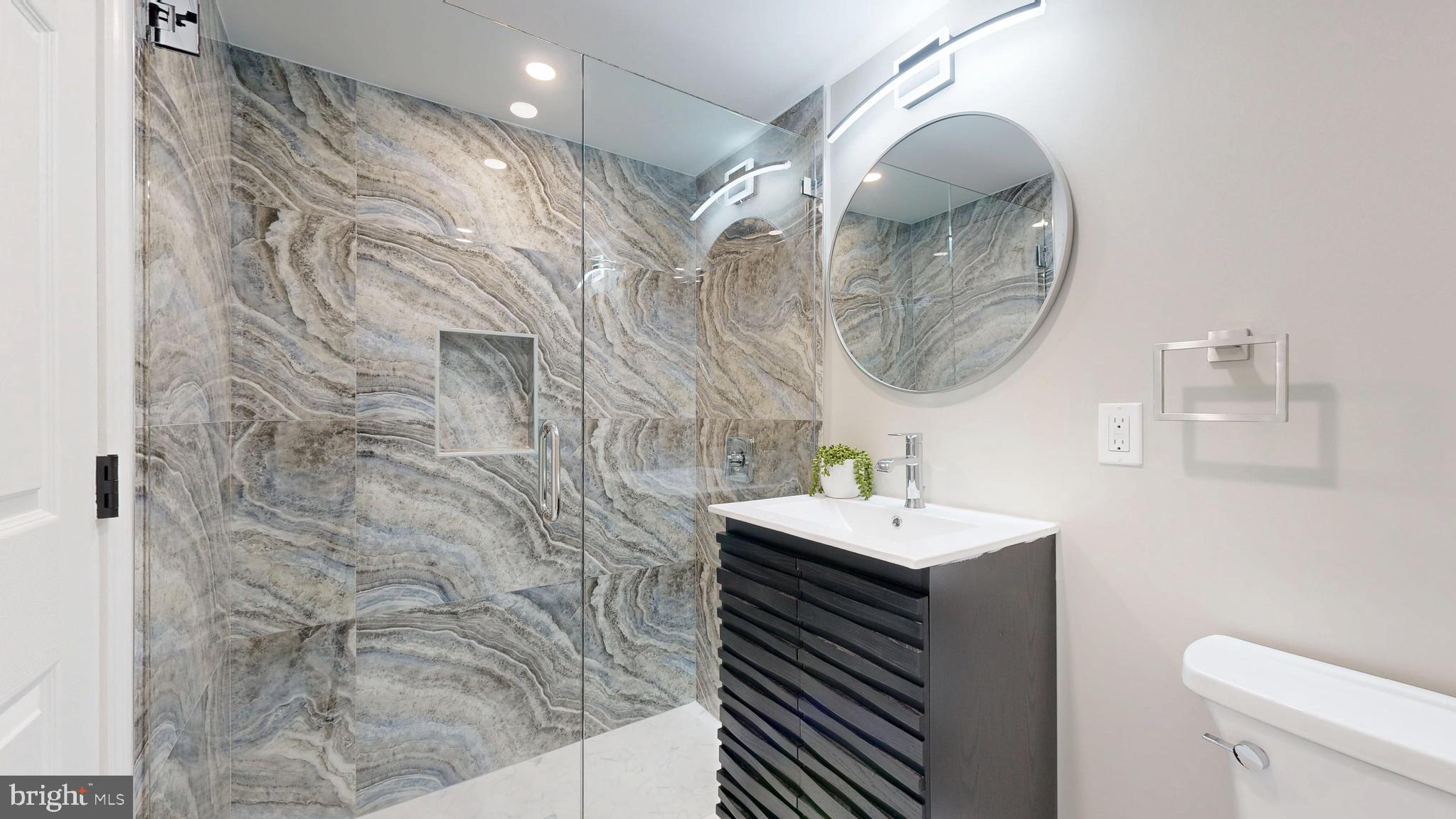 11101 Wedge Drive Reston, VA 20190 - Photo 23 of 55 a bathroom with a sink a toilet and a mirror