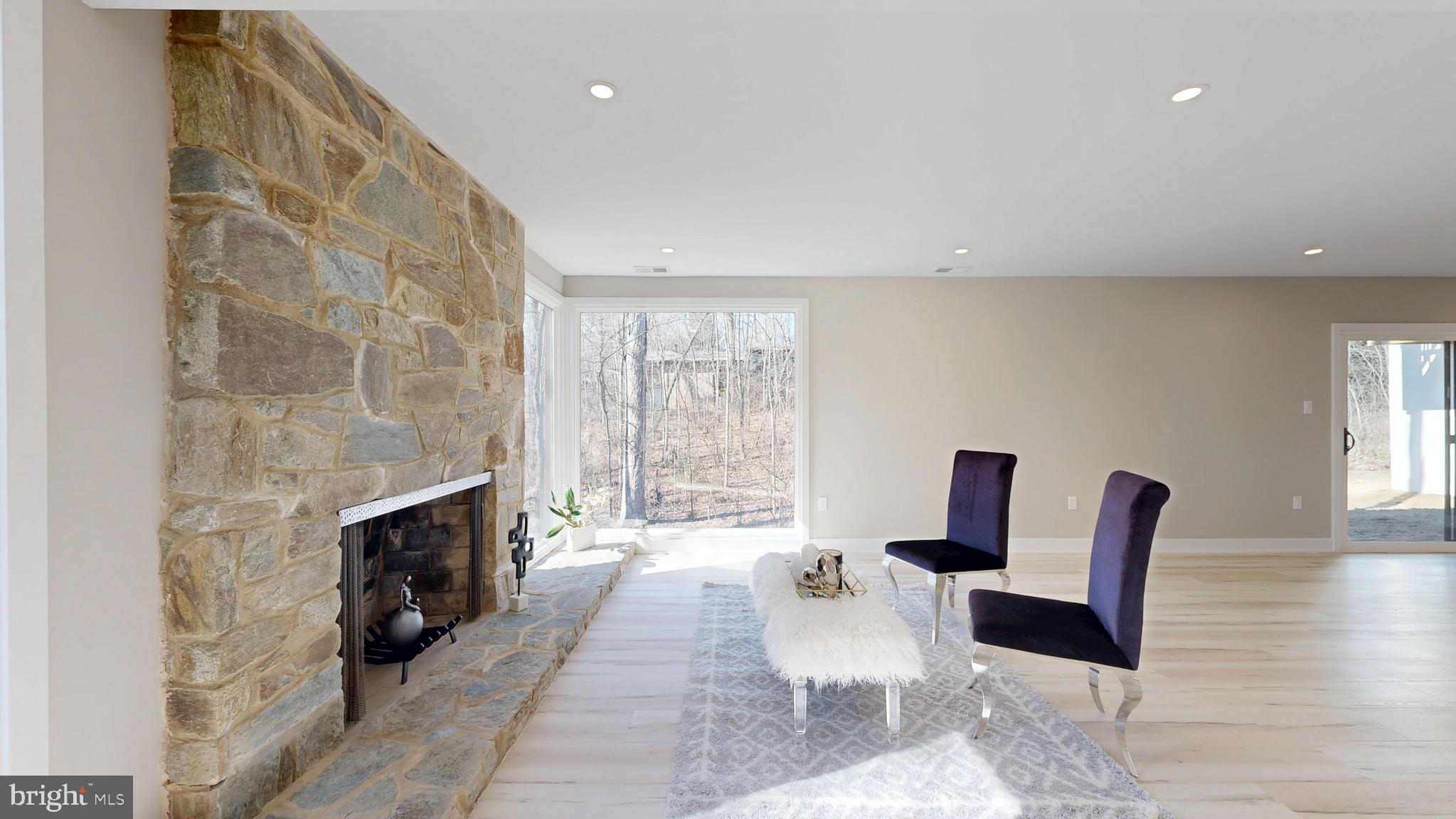 11101 Wedge Drive Reston, VA 20190 - Photo 36 of 55 a living room with furniture a fireplace and a floor to ceiling window