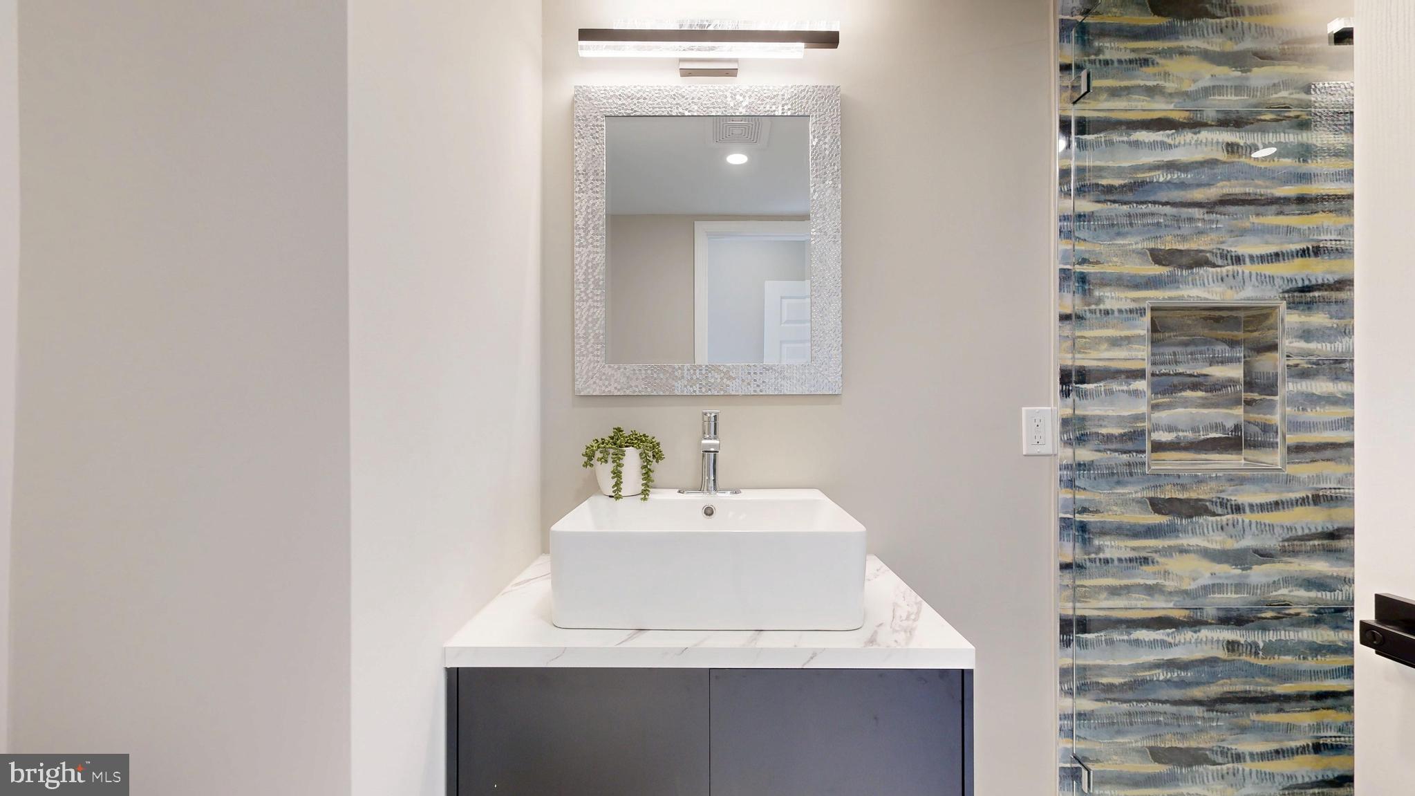11101 Wedge Drive Reston, VA 20190 - Photo 41 of 55 a bathroom with a sink and a mirror