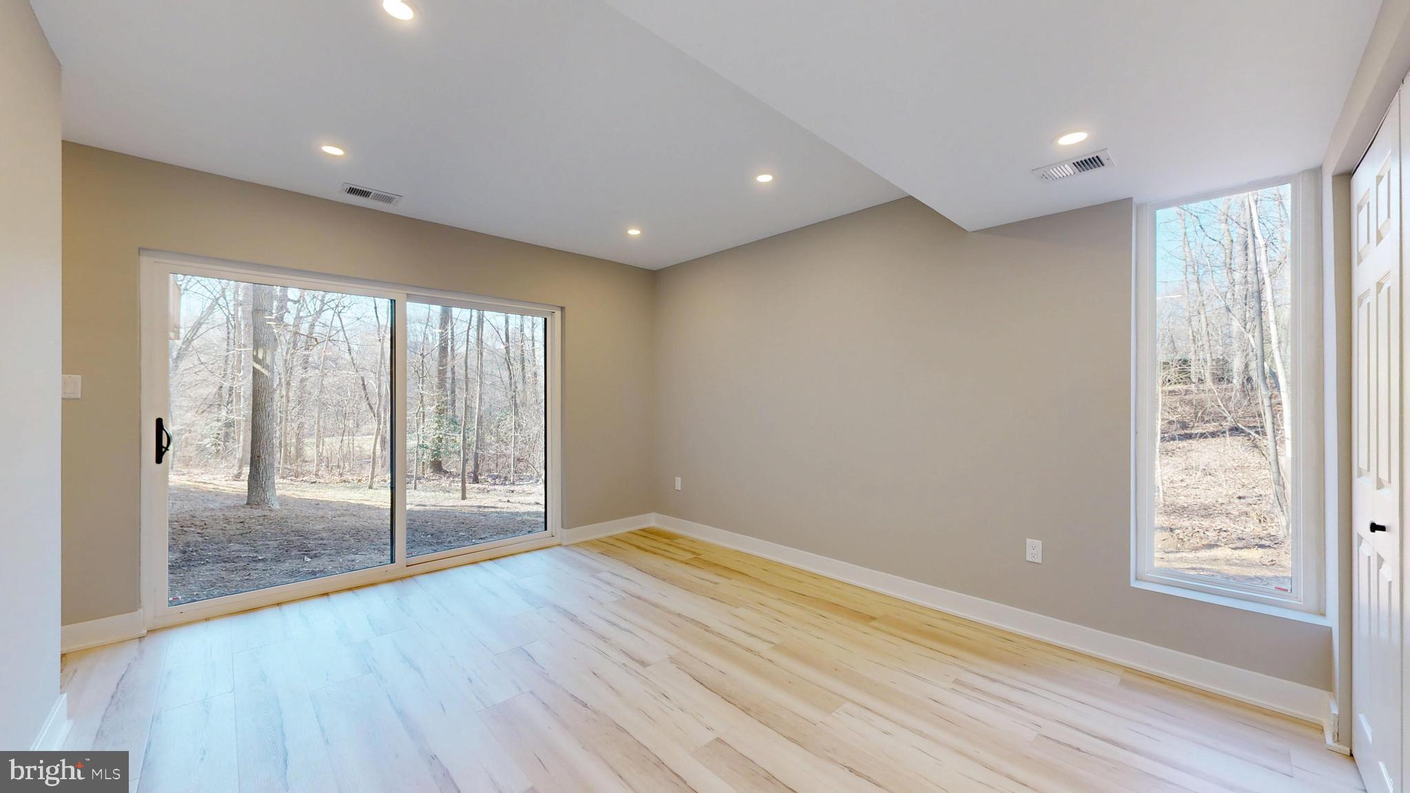 11101 Wedge Drive Reston, VA 20190 - Photo 44 of 55 a view of an empty room with wooden floor and a window