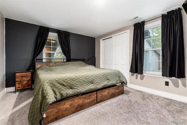a bedroom with a bed and window