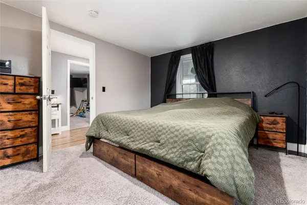 a spacious bedroom with a bed and a window