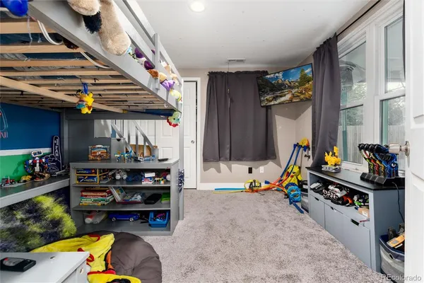 a bed room with a bed and a wooden floor