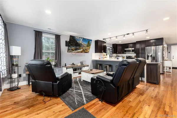 a living room with fireplace furniture and a flat screen tv