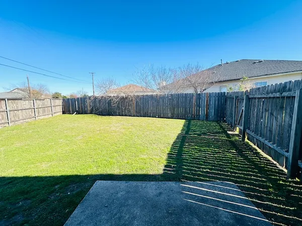a view of a backyard of the house