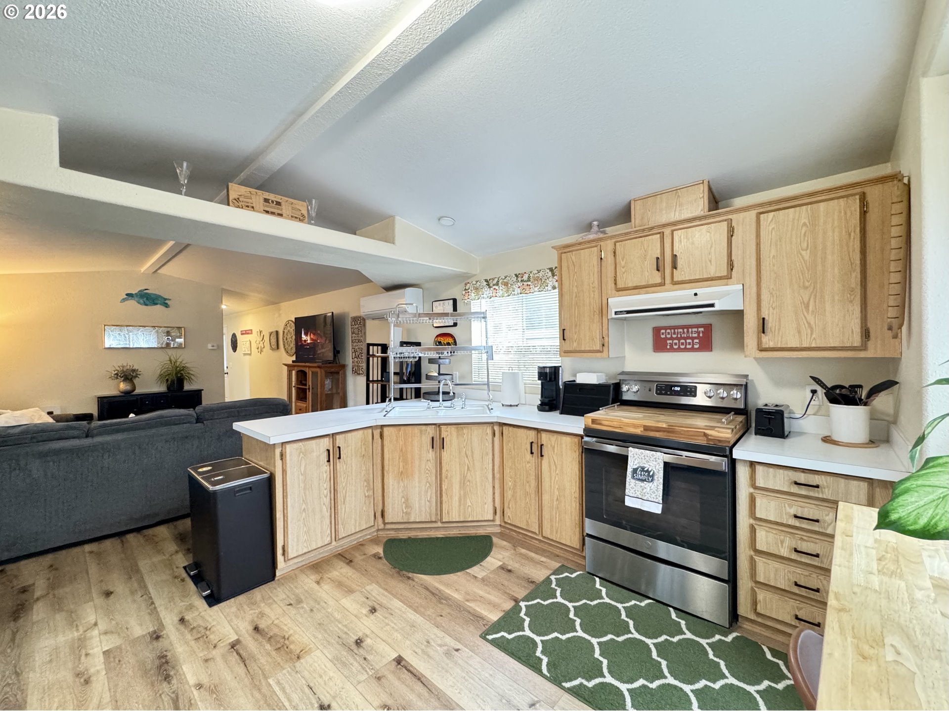 3760 Highway 101, Unit 1 Florence, OR 97439 - Photo 24 of 32 a kitchen with stainless steel appliances granite countertop a stove a sink and a microwave