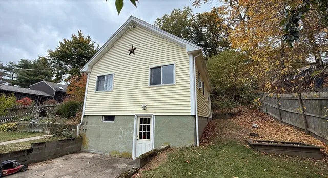 a view of a house with a yard and sitting area