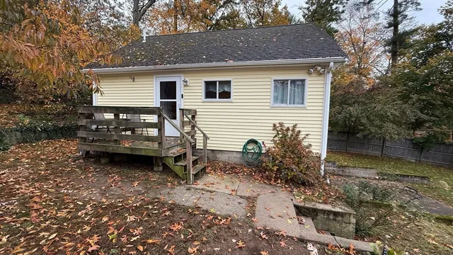 a view of a house with a yard and sitting area