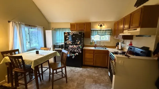 a view of a dining room with furniture and window