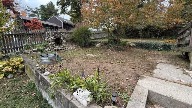 a view of a house with a yard and sitting area