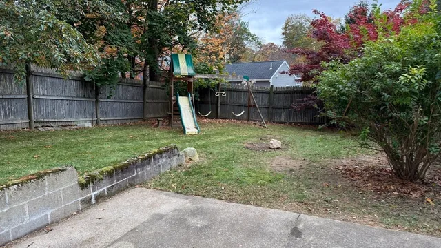 a view of a backyard with a garden and trees