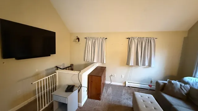 a bedroom with furniture and a flat screen tv