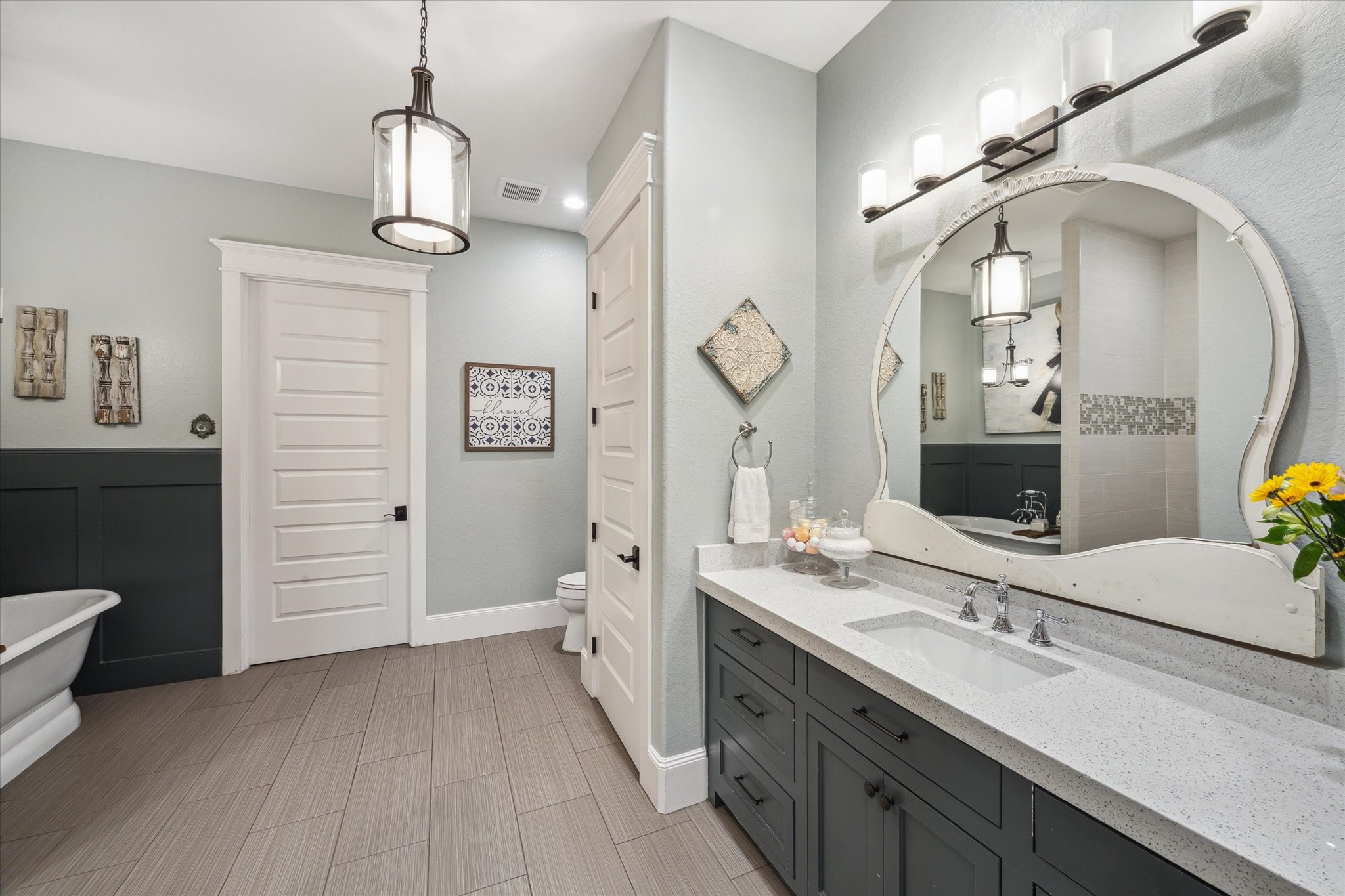 1255 Bronco Trail Angleton, TX 77515 - Photo 39 of 50 a spacious bathroom with a granite countertop sink a toilet a mirror and vanity