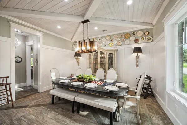 a view of a dining room with furniture and chandelier