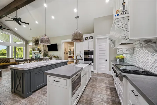a kitchen with stainless steel appliances granite countertop a stove and a wooden floors