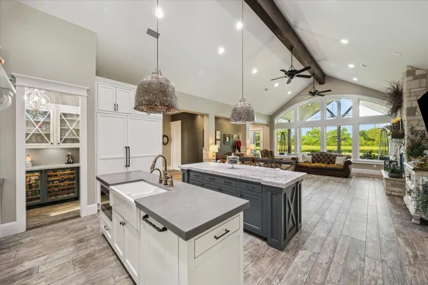 a kitchen with granite countertop lots of clutter and stainless steel appliances