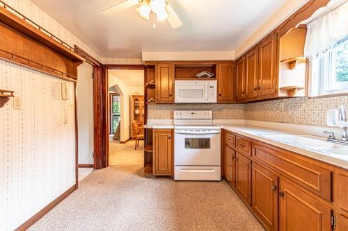 159 Craigdell Road Lower Burrell, PA 15068 - Photo 13 of 31 a kitchen with a stove a sink and a refrigerator
