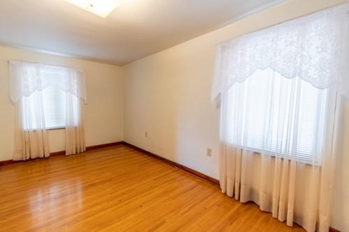 159 Craigdell Road Lower Burrell, PA 15068 - Photo 17 of 31 an empty room with wooden floor and windows