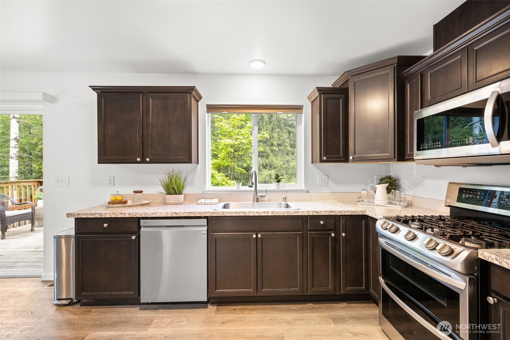 401 East Sunset Ridge Road Union, WA 98592 - Photo 8 of 37 a kitchen with a sink stove top oven and cabinets