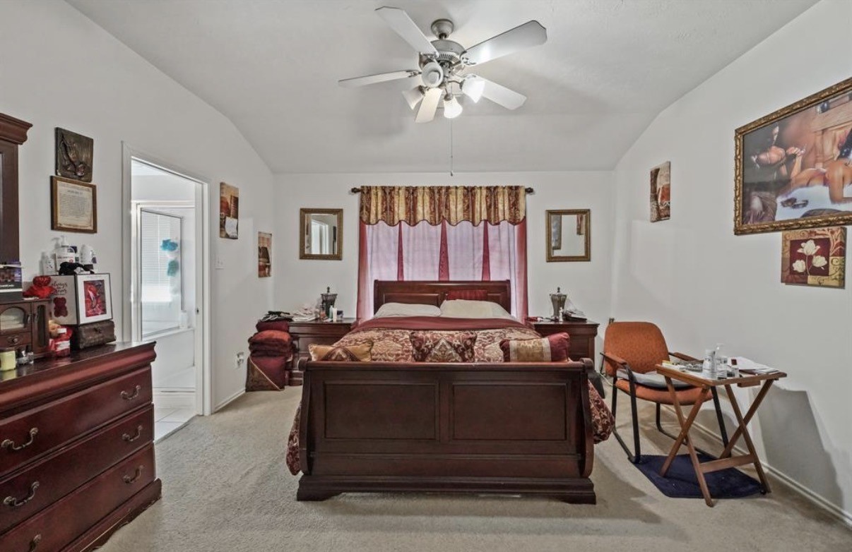 13134 Peppergate Lane Houston, TX 77044 - Photo 13 of 23 a bedroom with a bed and a dresser in it