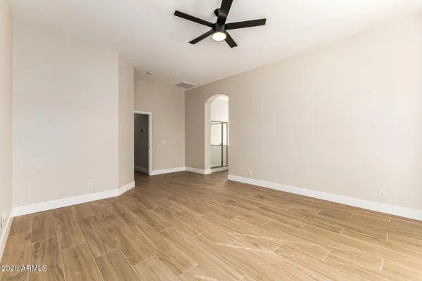 a view of a room with wooden floor and white walls