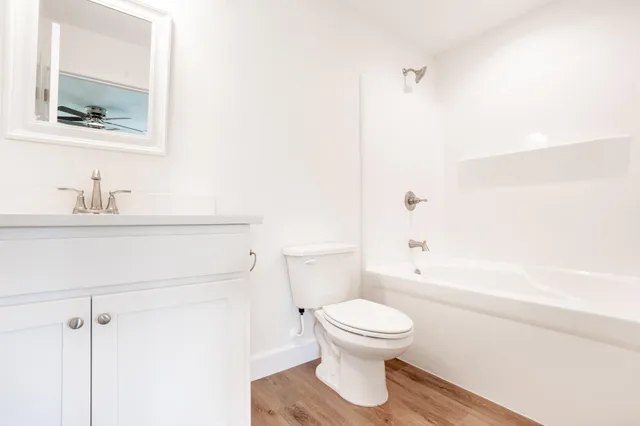 a white toilet sitting next to a bathroom sink