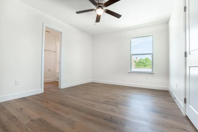 wooden floor in an empty room with a window