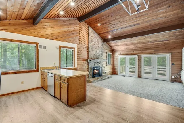 a view of a kitchen with wooden cabinets and a stove top oven