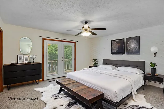 a bedroom with a bed a chandelier and a dresser