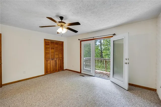 a view of a livingroom with a ceiling fan and a window