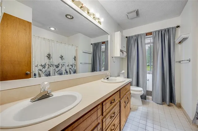 a bathroom with a double vanity sink mirror and double