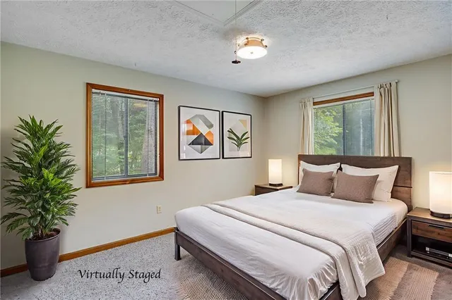 a bedroom with a large bed and a potted plant