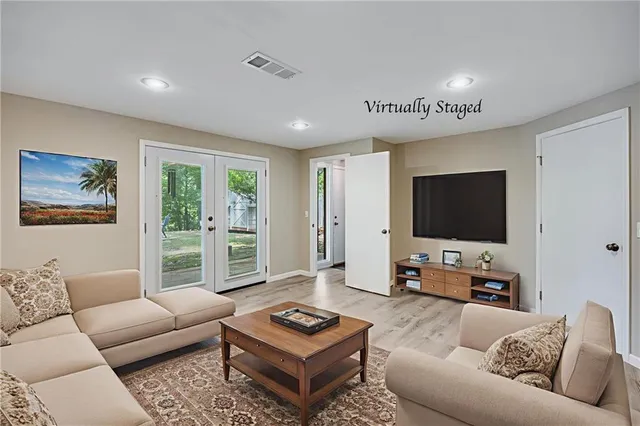 a living room with furniture and a flat screen tv