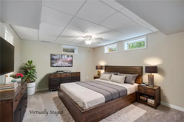 a bedroom with a bed and a potted plant