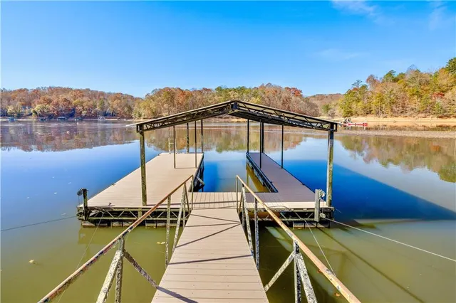a view of a balcony with chairs and wooden floor