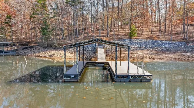 a view of a lake with a deck and a mountain view