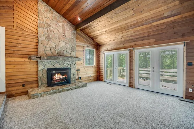 a view of an empty room with furniture and a fireplace