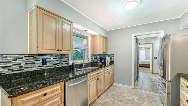 a kitchen that has a table and chairs in it