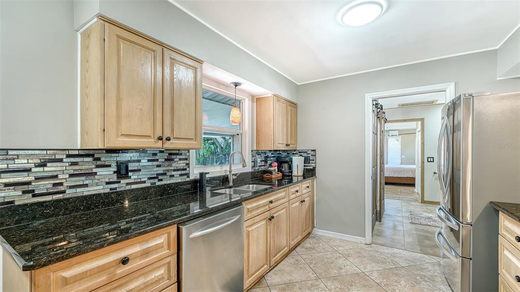 3818 Gocio Rd Extention Sarasota, FL 34235 - Photo 14 of 65 a kitchen with stainless steel appliances granite countertop a sink and a stove
