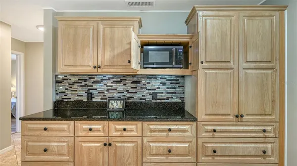 a kitchen with granite countertop a sink and a window