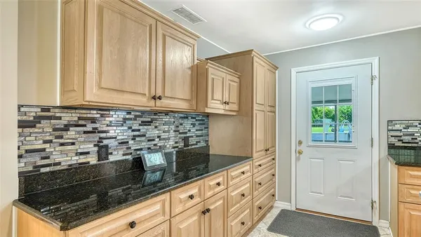 a kitchen with stainless steel appliances granite countertop a stove sink and cabinets