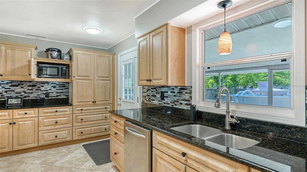 3818 Gocio Rd Extention Sarasota, FL 34235 - Photo 18 of 65 a kitchen with granite countertop a sink and a window