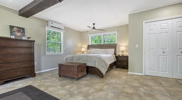 a bedroom with a bed and a chandelier