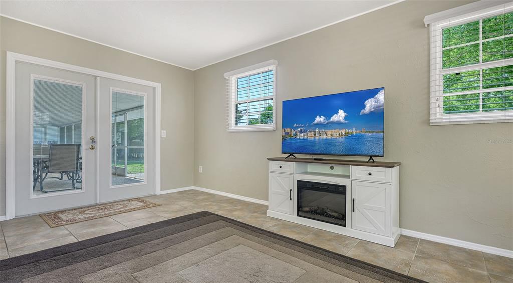 3818 Gocio Rd Extention Sarasota, FL 34235 - Photo 22 of 65 a view of an empty room with wooden floor and a window